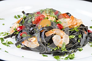 Black squid ink Fettuccine pasta with prawns or shrimps cherry tomatoes, parsley, chili in wine and butter sauce