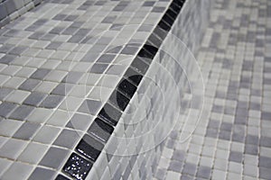 Black Stair edging tiles applied to refurbished swimming pool.