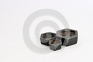 Black standard metric weights made of iron for weighing scales on white background