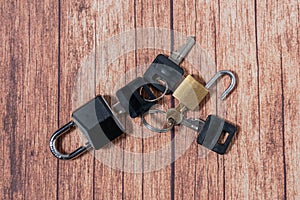 Black steel padlock with keys on a wooden background. Concept of security and tranquility