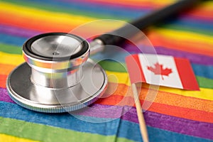 Black stethoscope and Canada flag on rainbow background, symbol of LGBT pride month  celebrate annual in June social, symbol of