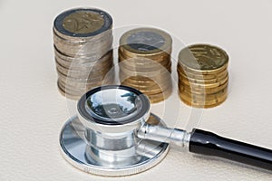 Black stethoscope and euros coins
