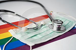 Black stethoscope with mask on rainbow flag background, symbol of LGBT pride month  celebrate annual in June social, symbol of gay