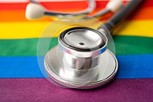 Black stethoscope on rainbow flag background, symbol of LGBT pride month celebrate annual in June social, symbol of gay, lesbian,