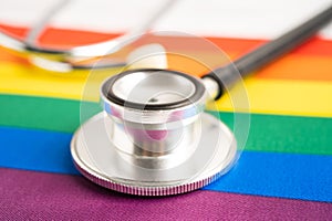 Black stethoscope on rainbow flag with heart, symbol of LGBT pride month celebrate annual in June social, symbol of gay, lesbian,