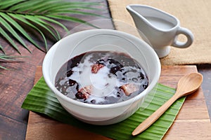 Black sticky rice pudding with taro and coconut milk at close up view -  Thai dessert called Khao Nieow Dam