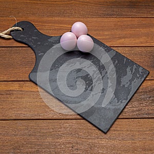 Black stone board with easter eggs with space for text
