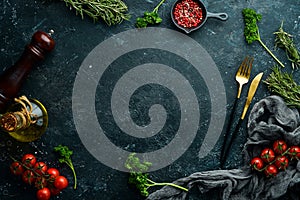 Black stone kitchen background. Kitchen board, vegetables and spices on a black background.