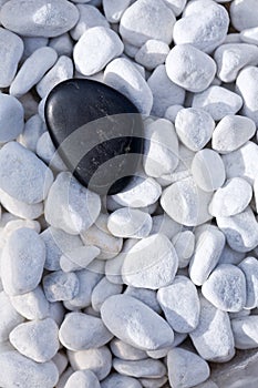 Black stone on pebbles