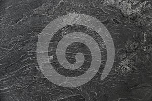 A black stone wall with a rough texture