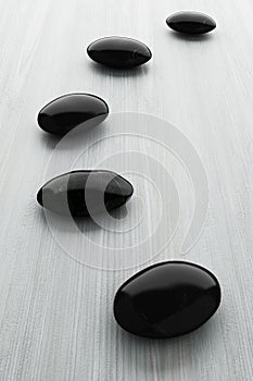 Black stone, zen spa on white wood
