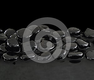 Black stones on calm water