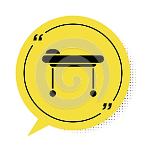 Black Stretcher icon isolated on white background. Patient hospital medical stretcher. Yellow speech bubble symbol