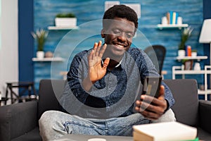 Black student greeting university collegue during online videocall