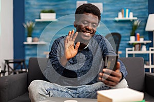 Black student greeting university collegue during online videocall photo