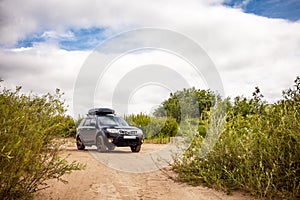 Black Subaru Forester at sandy river coast