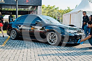 Black Subaru WRX STI sedan in car modification show