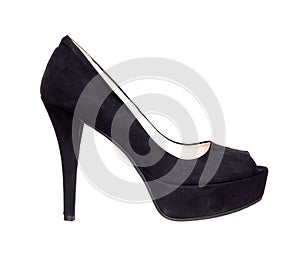 Black suede court shoe with platform sole, isolated on white. Woman`s footwear with ridiculously high heel.
