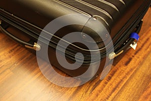 Black suitcase on wooden floor photo