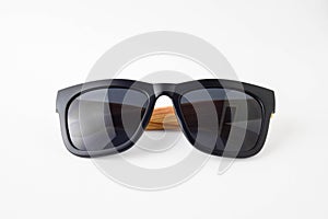 Black sun glassess wooden legs on white background