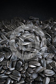 Black sunflower seeds background with copy space