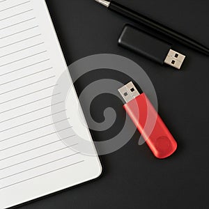 On the left with visible turning lines while the pen and USBs are