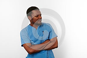 Black surgeon doctor bearded man in blue coat with crossed arms isolated white background copy space