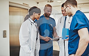 Black surgeon giving instruction to medical team