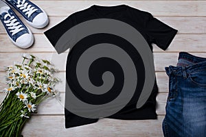 Black T-shirt mockup with daisy flowers and jeans