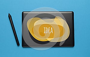 Black tablet for drawing on PC isolated on blue background, idea search concept