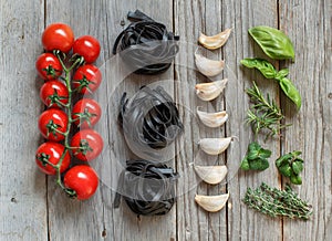 Black Tagliatelle pasta with cherry tomatoes, garlic and herbs