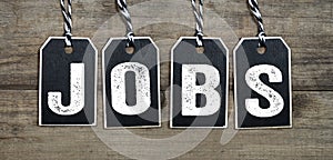 Black tags on natural wood with Jobs