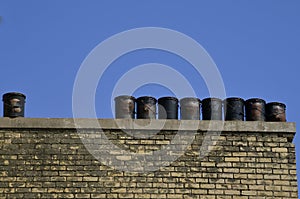 Black tar pails setting on roof ledge