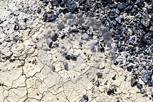 Black Tarmac and Cracked Dirt Road