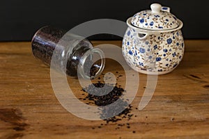 Black tea in a bottle and a teapot of flowers photo