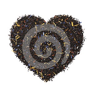 Black tea with dried flower leaves in heart shape isolated on white background