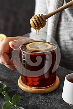 Black tea in glass cup, morning hot drink with lemon and honey