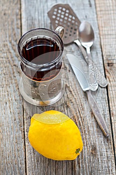 Black tea in glass and lemon.