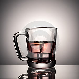 Black tea with ice in glass cup on white background