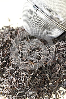 Black tea leaves with tea strainer