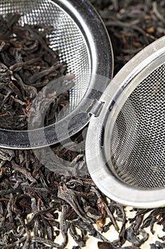 Black tea leaves with tea strainer