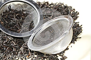 Black tea leaves with tea strainer