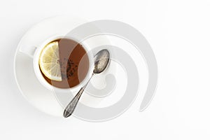 Black tea with lemon and honey on a white background. Hot tea cup isolated, top view flat lay. Flat lay. Autumn, fall or winter