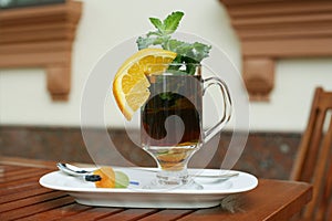 Black tea with orange, mint and dried fruits on a