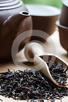 Black tea, teapot and cups on the table