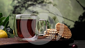 Black tea, waffles, brown sugar. Close-up 4k video shooting, dark background