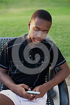 Black Teen Boy Using His Cell Phone