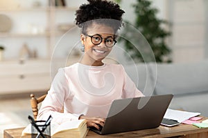 Black Teen Girl At Laptop Learning Online Sitting At Home