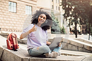 Black Teenager Girl Learning Online Using Laptop Showing Like Outside