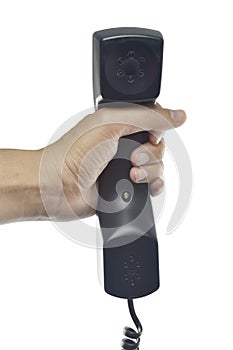 Black telephone receiver with hand on white background.